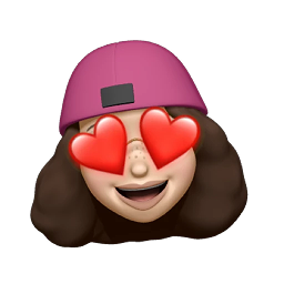 Mary — Heart Eye A playful young woman with a beanie, gold-rim glasses, freckles, and fluffy curls. A heart-eyes love reaction.